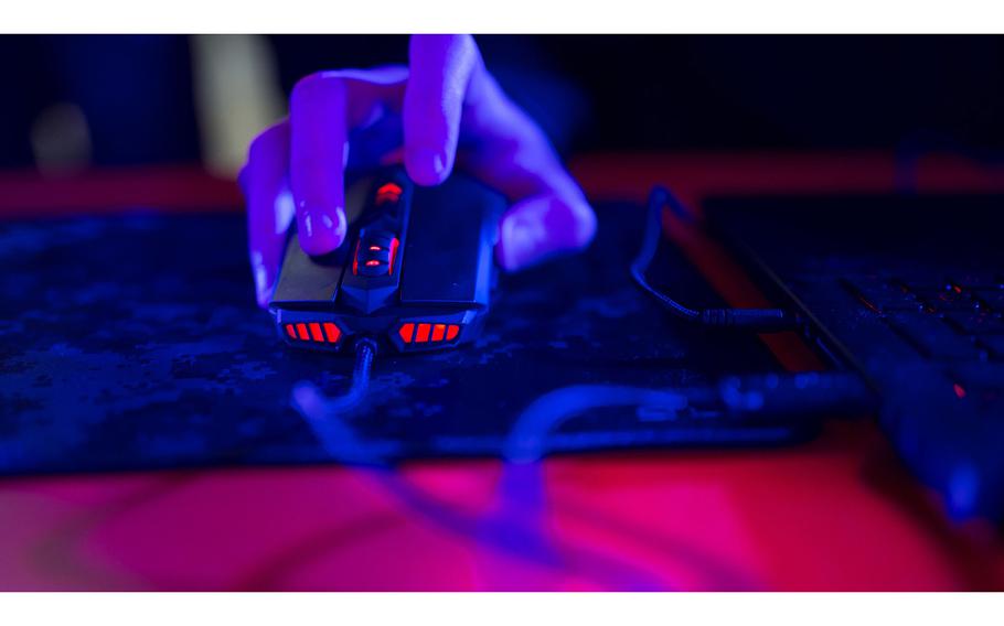A photo illustration shows a person’s hand operating a computer mouse to depict how hackers break into computer systems.
