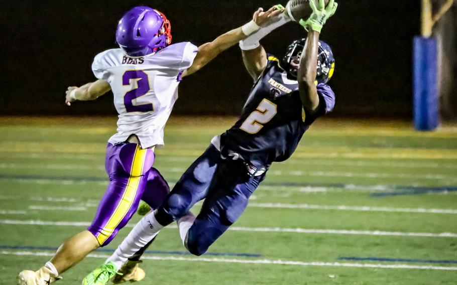 Guam High's Ben Harris intercepts a pass in front of George Washington's Marcello Blas.