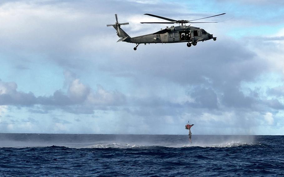 A U.S. Navy MH-60 Knighthawk from Helicopter Sea Combat Squadron 25 rescues three divers off the coast of Agat, Guam, Oct. 28, 2023.