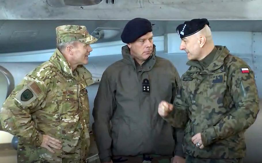 U.S. Air Force Gen. Tod Wolters, left, who serves as NATO Supreme Allied Commander Europe, and Dutch Adm. Rob Bauer, center, chair of NATO’s military committee, listen to Gen. Rajmund Andrzejczak, chief of the general staff of the Polish armed forces at Lask Air Base, Poland, March 1, 2022. NATO Secretary-General Jens Stoltenberg and Polish President Andrzej Duda were meeting at the base.