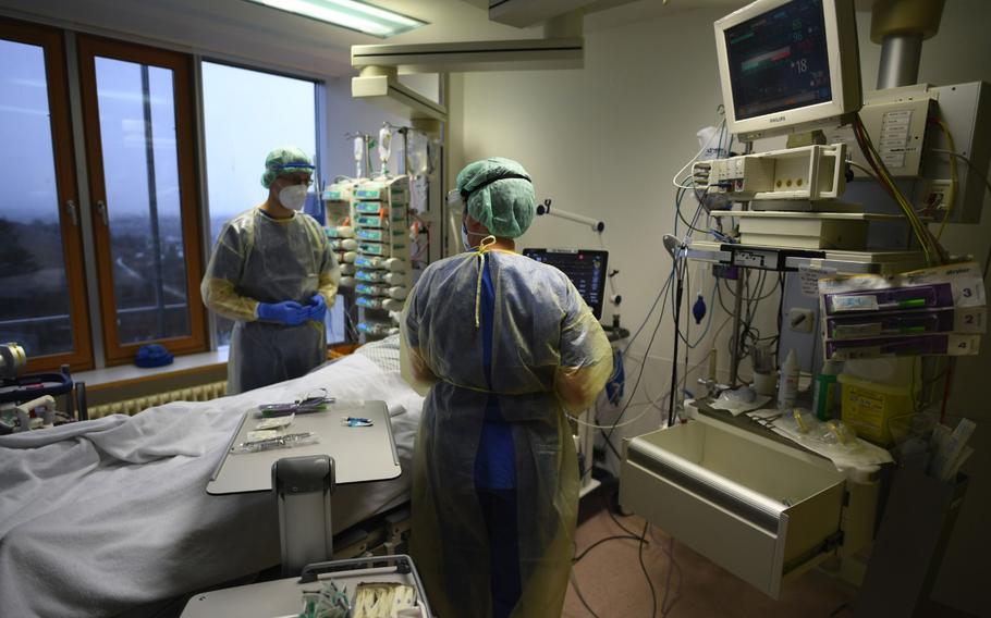 Health care workers care for a COVID-19 patient in the ICU ward at the Robert Bosch Hospital in Stuttgart, Germany, on Jan. 12, 2021. 