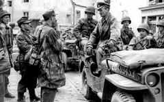Lawrence Riordan/Stars and Stripes
St. Malo, France, August, 1944: German Col. Andreas von Auloch, standing in the Jeep, talks to some of his men as he waits to be taken to a POW camp shortly after his surrender to U.S. troops. The monocled von Auloch, an Iron Cross recipient from both world wars who was known to GIs as "The Madman of St. Malo," held out for several days in an underground bunker after the city was captured by the Americans.