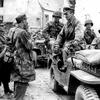 Lawrence Riordan/Stars and Stripes
St. Malo, France, August, 1944: German Col. Andreas von Auloch, standing in the Jeep, talks to some of his men as he waits to be taken to a POW camp shortly after his surrender to U.S. troops. The monocled von Auloch, an Iron Cross recipient from both world wars who was known to GIs as "The Madman of St. Malo," held out for several days in an underground bunker after the city was captured by the Americans.