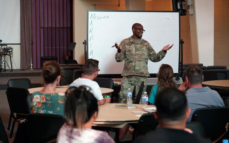 Army Chaplain (Maj.) Cornelius Muasa oversees the Wellness on Wednesday personal growth curriculum with help from volunteers at Torii Station Chapel on Okinawa. 