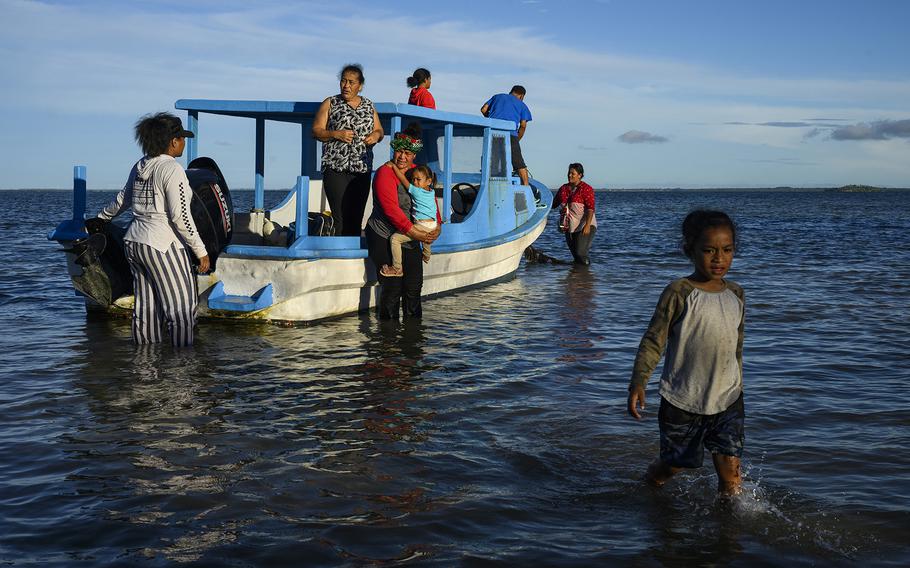 Lisala Folau and his family make their way to the shore of Atata island, where they used to live before the tsunami. 