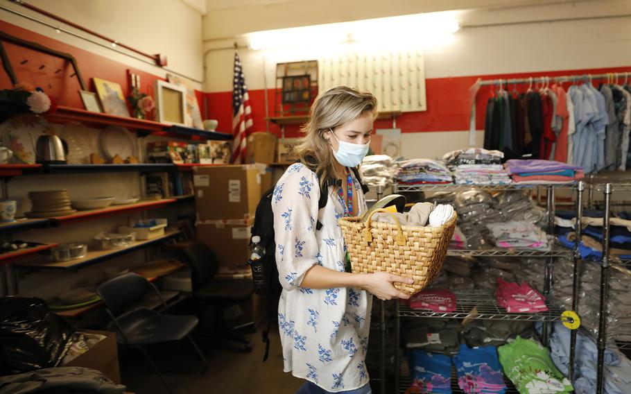 Hope Shaw, a Navy veteran and housing specialist for PATH (People Assisting The Homeless), collects items in the non-profits storage area to take to a client that was recently housed on Monday, Sept. 19, 2022, in San Diego, California.