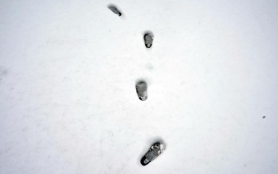 Footprints decorate fresh snow at the Sagamihara Housing Area near Camp Zama, Japan, Tuesday, Feb. 6, 2024.
