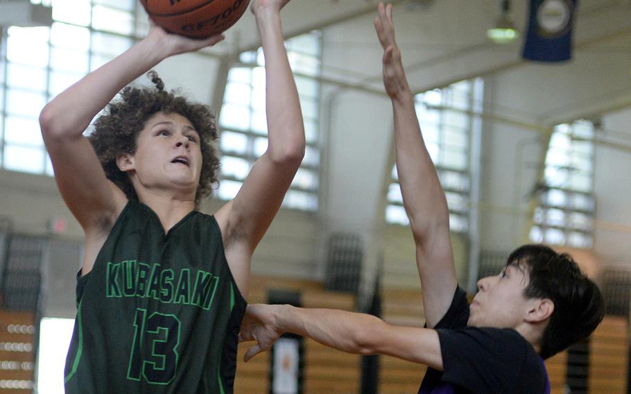 Kubasaki's Alex Hye goes up for a shot against Zion Christian during Saturday's pool-play game in the 16th Okinawa-American Friendship Basketball Tournament at the Camp Foster Field House. The Lions edged the Dragons 55-54.