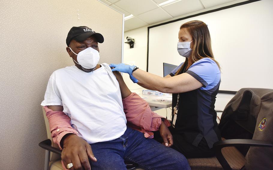 In this March 20, 2021, file photo, Navy veteran Ronnie Jackson, of Blakeslee, Pa., receives a COVID-19 vaccine from nurse Fran McLean at the Wilkes-Barre VA Medical Center in Plains Township, Pa. The Department of Veterans Affairs reported nearly 23,000 active cases of the coronavirus Wednesday — more than at any other point during the pandemic.