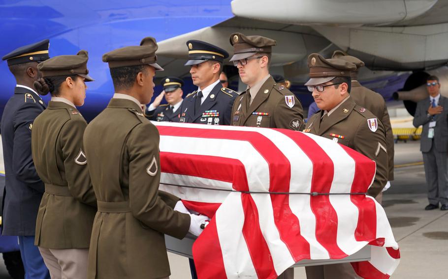 A casket holding the remains of U.S. Army Air Forces Staff Sgt. Robert Ferris Jr. is carried from a plane at Raleigh-Durham International Airport, N.C., May 16, 2024.
