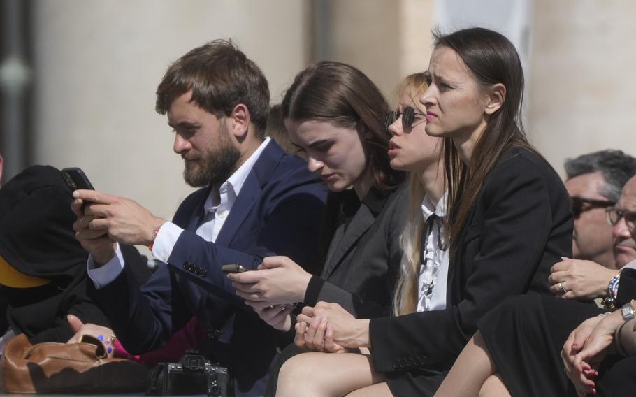 Kateryna Prokopenko, center, wife of Azov Commander Denys Prokopenko, and Yuliia Fedosiuk, second from left, from Ukraine attend Pope Francis weekly general audience in St. Peter’s Square at the Vatican, Wednesday, May 11, 2022.