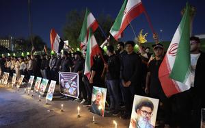 Protesters gather in front of the Iranian embassy carrying candles and Iranian flags during a stand honoring the Iranian armed forces generals, nuclear scientists, and their family members who were killed in Israeli strikes, in Baghdad, Iraq, Saturday, June 28, 2025. (AP Photo/Hadi Mizban)