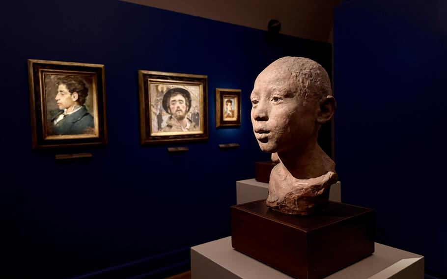 Sculptures and paintings on display at a museum.