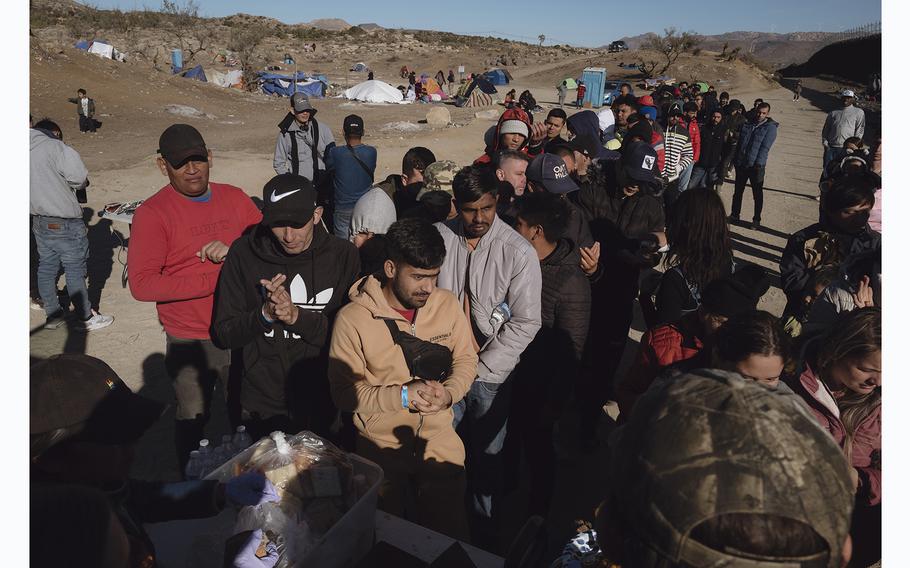 Local volunteers distribute food to migrants in Jacumba Hot Springs, Calif., on Dec. 14, 2023.