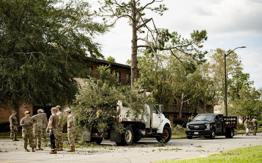 Airmen cleanup debris from a hurricane