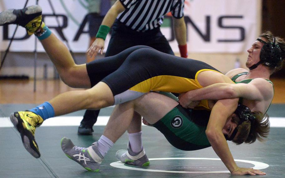 Kadena's Joey Puterbaugh sends himself and Kubasaki's Brandon Revay tumbling to the mat during the 180-pound bout in Wednesday's Okinawa wrestling dual meet. Puterbaugh pinned Revay in 2 minutes, 22 seconds and the Dragons won the dual meet 37-25.