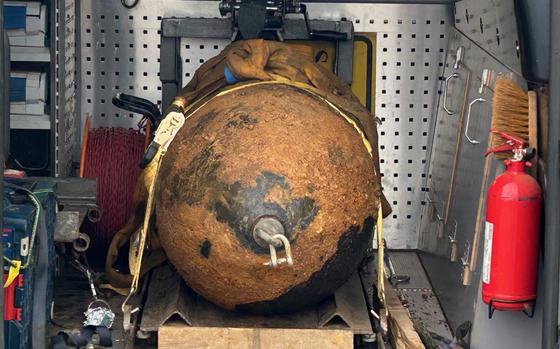 A roughly 1,000-pound American WWII aerial bomb is secured after being defused by specialists in a section of Amberg, Germany, April 4, 2024.

