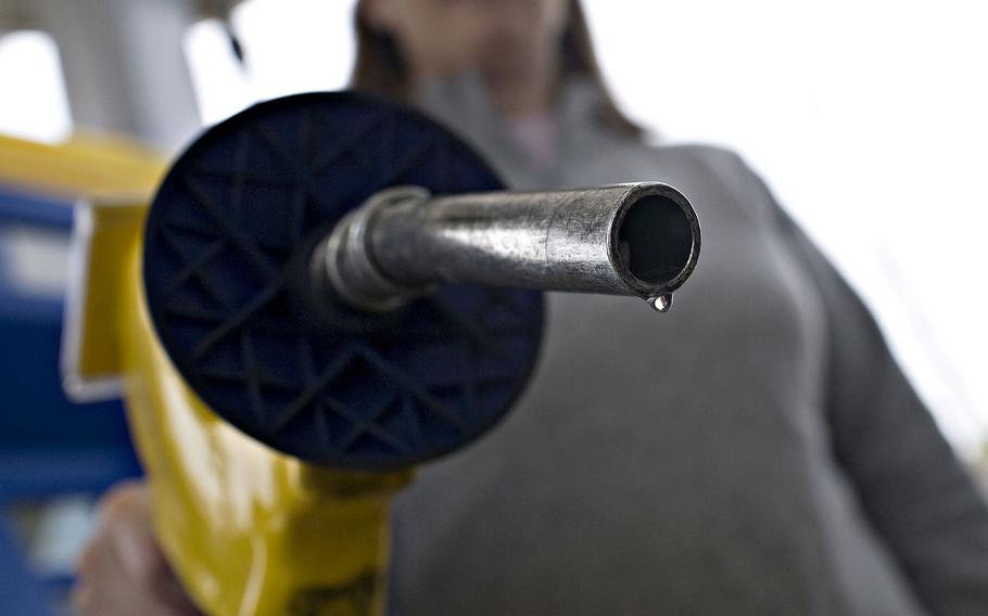 A drop of E85, a mixture of 85 percent ethanol and gasoline, hangs at the end of a pump at a gas station in Birmingham, Michigan. 