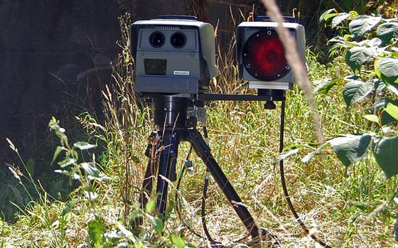 An automatic speed camera enforces the speed limit on a German roadside.