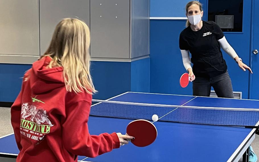 Military spouse Elizebeth Frost and her daughter, Madeline Frost, wear masks during a game of table tennis at Yokota Air Base, Japan, Jan. 14, 2022.