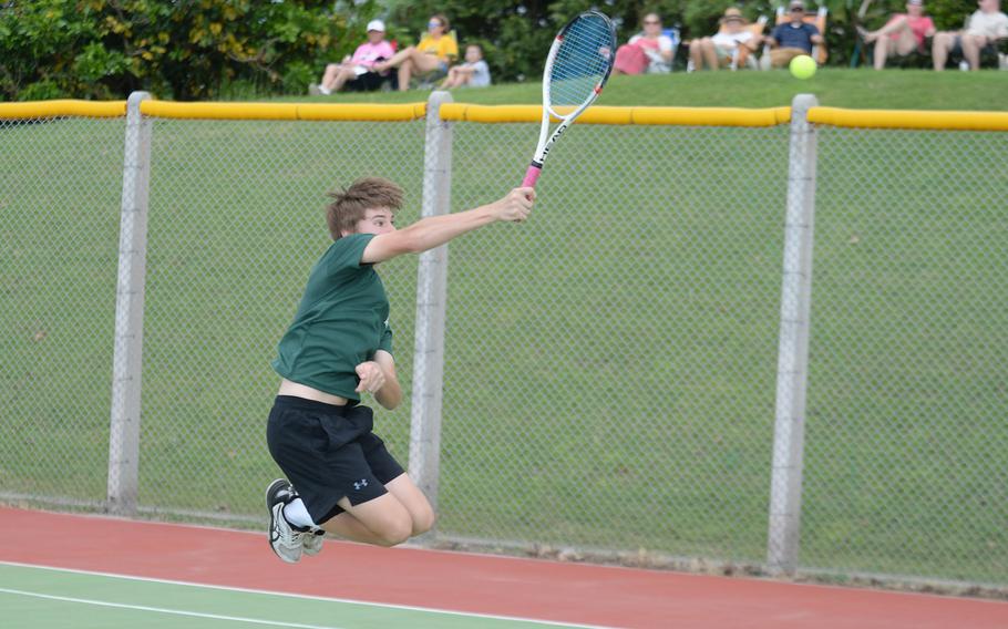 Kubasaki's Owen Ruksc leaps to make an overhead smash against Kadena during Thursday's Okinawa mixed-doubles matches. Ruksc and partner Noemi Ung lost to the Panthers' Nathan Asato and Mary Tracy 8-5.