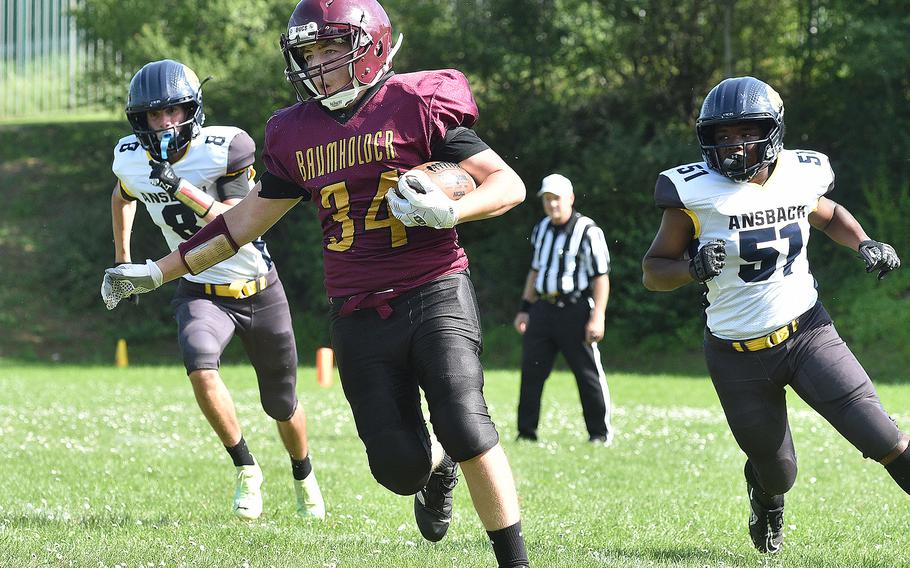 Buccaneer running back George Corbin surveys his next move during a Sept. 16, 2023, game against Ansbach at Baumholder Middle High School in Baumholder, Germany. Chasing are, from left, Ansbach defenders Nathan Arreguin and Derek Richard.