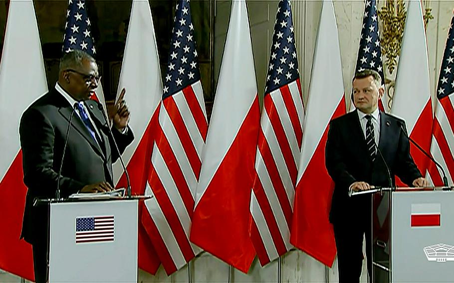 Polish Defense Minister Mariusz Blaszczak listens as U.S. Defense Secretary Lloyd Austin answers a reporter's question in Warsaw, Feb. 18, 2022. Austin was to meet later with service members deployed to Poland. 