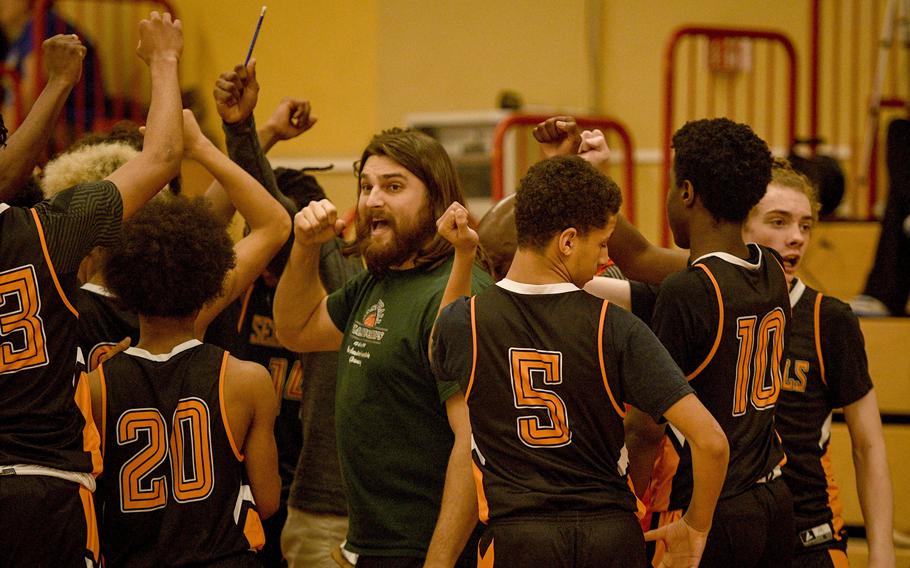 Spangdahlem coach Matthew Cirillo rallies his team during a timeout during a DODEA-Europe Division III basketball semifinal game Feb. 17, 2023, in Baumholder, Germany.