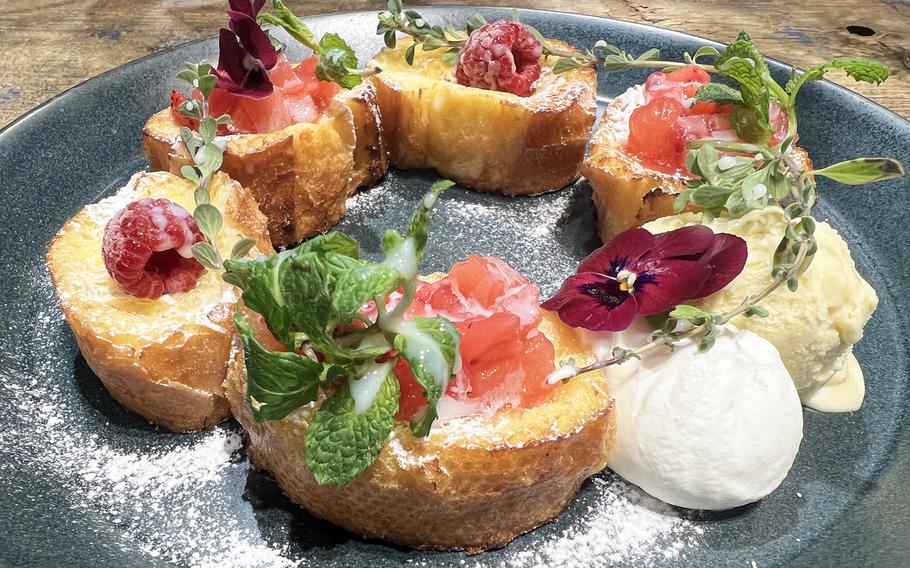 The French toast from Aoyama Flower Market Tea House in Tokyo is just topped with powdered sugar and berries with a dollop of ice cream and whipped cream on the side. 