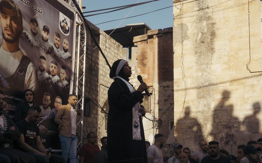 The mother of Mohammad al-Azizi, one of the founders of the Lions’ Den militant group, speaks during a public ceremony to celebrate her son and two other “martyrs” in the Old City of Nablus.