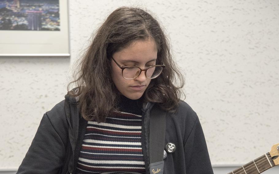 Daniela Reyes, 18, a senior at Zama High School, plays rhythm guitar for Utraviolet during rehearsal at the Taiyo Community Center at Yokota Air Base, Japan, on Nov. 15, 2022. 