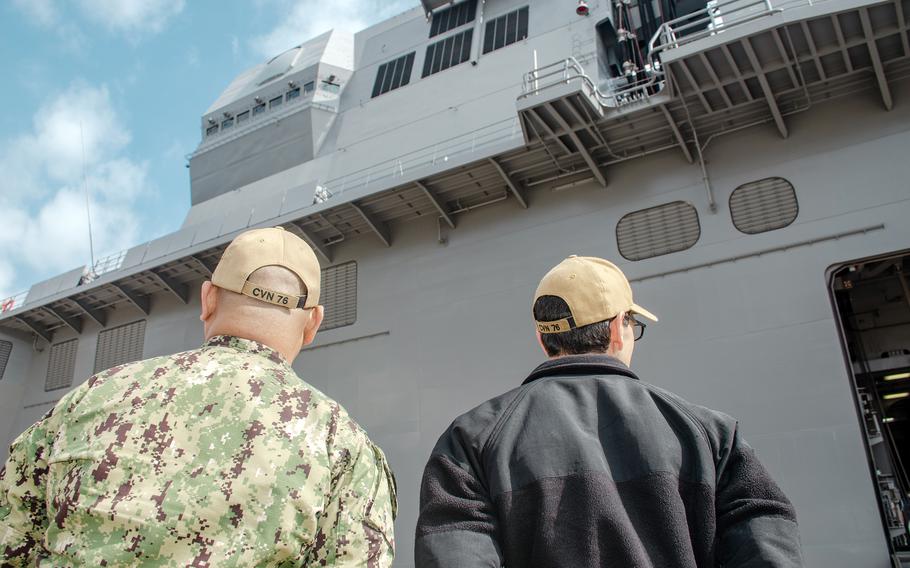 Petty Officers 1st Class Randy Gudelosao, left, and Adrian Gonzales take a tour of the JS Izumo in Yokosuka, Japan, April 2, 2024.