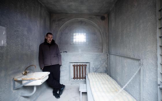 Oleg Navalny, the brother of Alexey Navalny pose for media inside a replica of a punishment cell in Berlin, Germany, Tuesday, Jan. 24, 2023. Supporters of jailed Alexey Navalny install a replica off the cell in which he has spend 91 days in 2022 opposite the Russian embassy in the German capital. (AP Photo/Markus Schreiber)