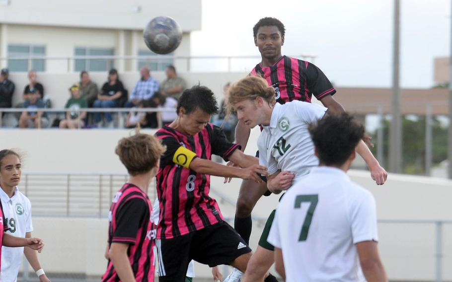 Kadena's Tuck Renquist and Kubasaki's Joseph Endeola try to head the ball during Wednesday's DODEA-Okinawa boys soccer match. The Panthers won 8-0.