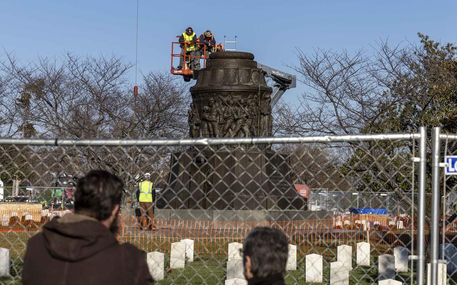 A construction crew works to remove the Confederate Memorial at Arlington National Cemetery on Dec. 20.