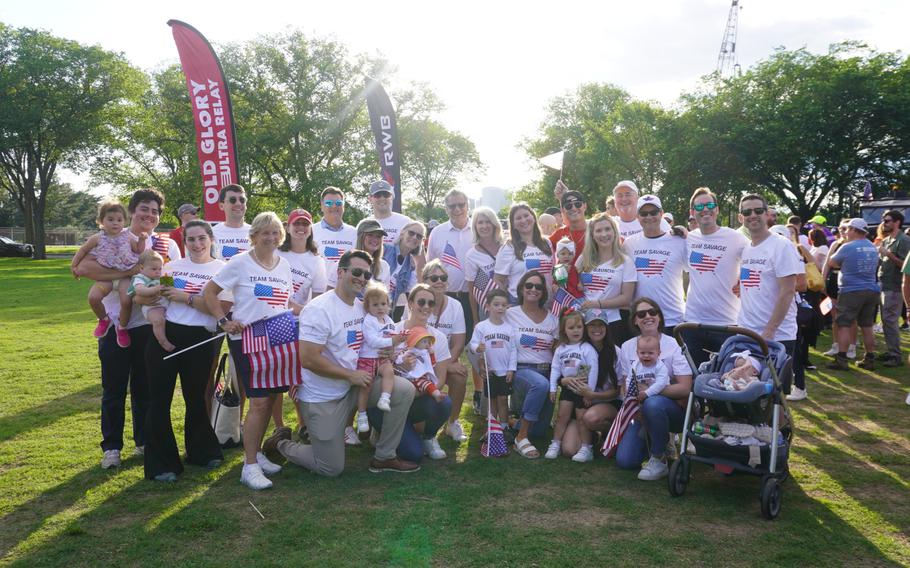 A group of people wearing American flag shirts pose for a photo