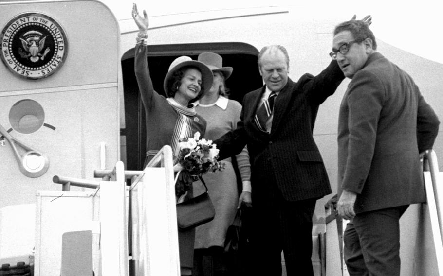 President Gerald Ford and his wife, Betty, wave as they board Air Force One at Haneda Airport on Dec. 1, 1975, to continue on their trip to China. Climbing the steps is Secretary of State Henry Kissinger; in the background is the Fords’ daughter, Susan.