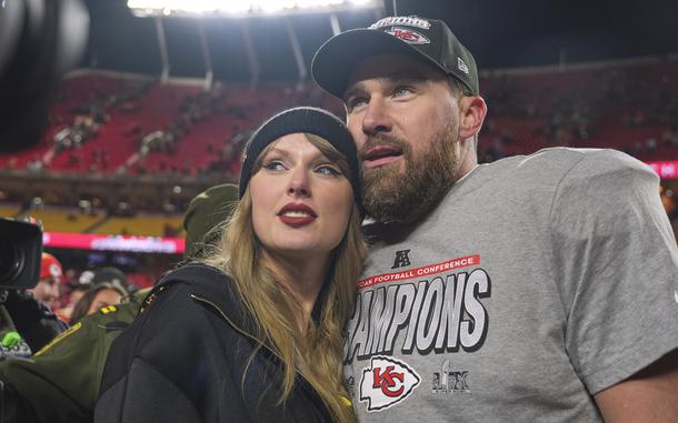 Taylor Swift leans against Travis Kelce’s shoulder, both in hats.