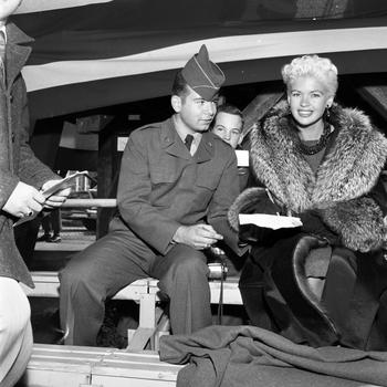 Jayne Mansfield poses with Spc. 2nd Class Martin A. August in the bleachers of the Frankfurt Football Stadium, Oct. 5, 1957. The actress was there to attend the game between Northern Area Command’s Black Knights and 10th Division Trains.