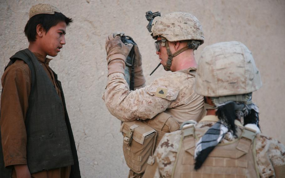 Marine Corps Cpl. Brandon Withers, assigned to 2nd Battalion, 5th Marine Regiment, Regimental Combat Team 6, uses handheld identity detection equipment to record the biometric information of an Afghan national in Ganbum Rece, Helmand province, Afghanistan, July 18, 2012. Human rights analysts believe the Taliban may be using the data to track down former Afghan soldiers and others who aided U.S. and coalition efforts.