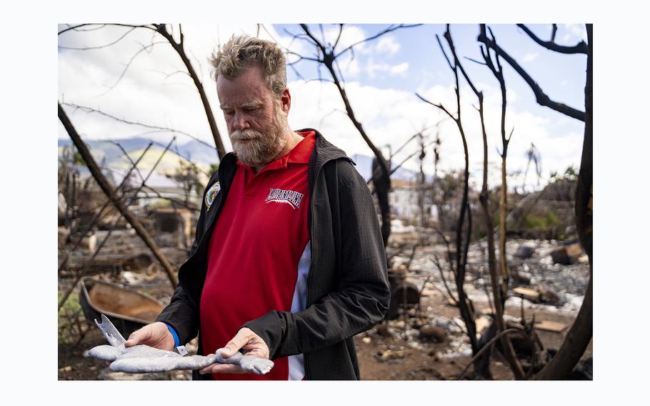 State Sen. Angus McKelvey holds a piece of melted aluminum, a remnant of his car that burned during the August wildfire in Lahaina. McKelvey also lost his home in the blaze and has been living in hotel shelters since. 