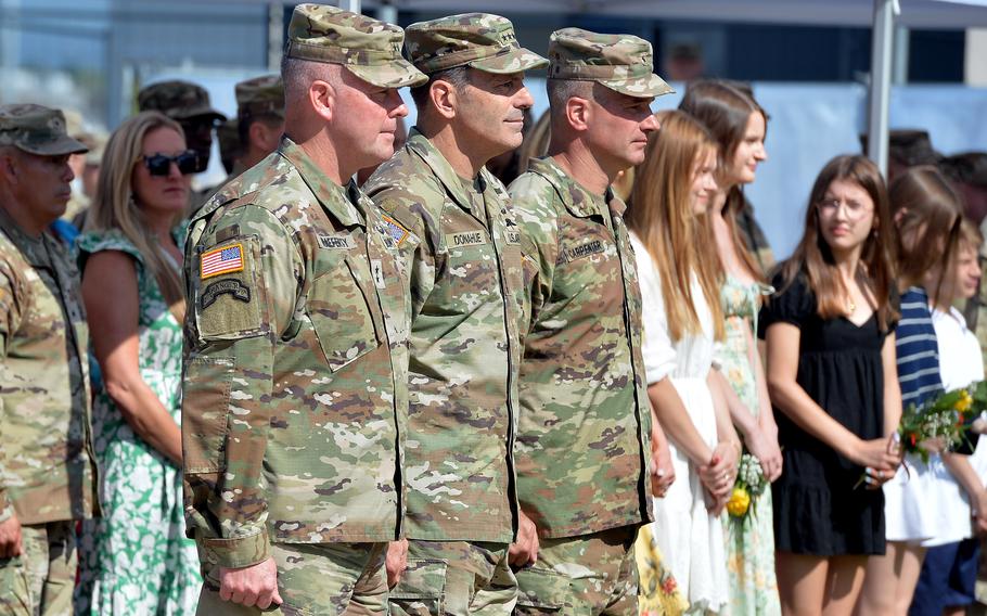 Generals stand side by side during a change of command.