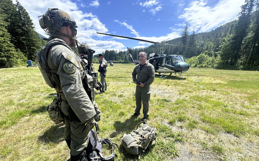 Deputies standing near a helicopter.