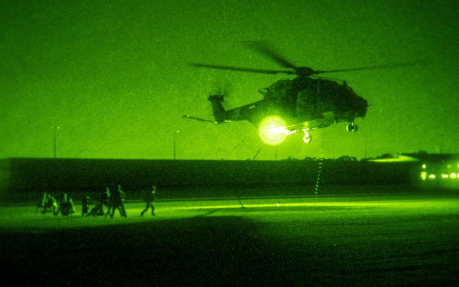 U.S. sailors and Australian soldiers conduct nighttime fast-rope training from an MRH-90 Taipan helicopter during the Talisman Sabre exercise in Sydney, July 17, 2023. 