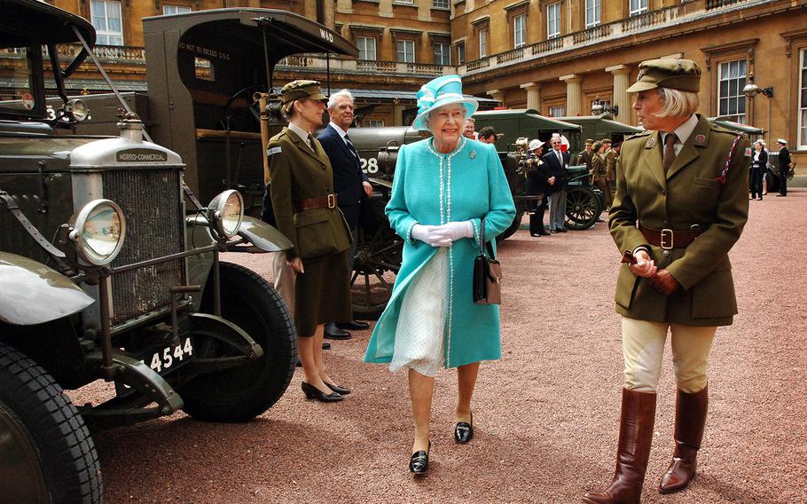Former Queen Elizabeth II, accompanied by Commandant Lynda Rose, right, inspects vintage vehicles used by the First Aid Nursing Yeomanry, in which she herself served during WWII. The vehicles assembled in the quadrangle of Buckingham Palace, London on June 28, 2007, to mark the centenary of the corps. 