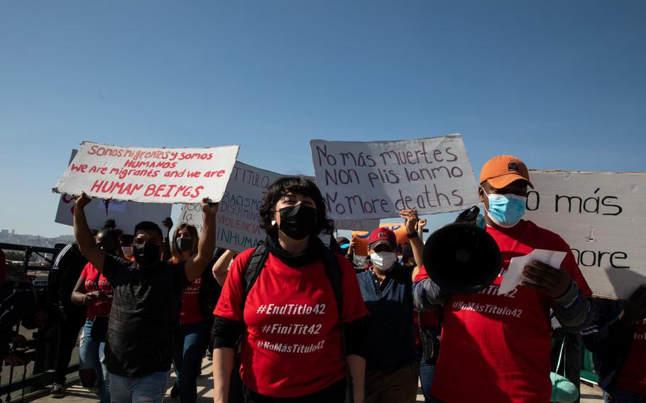 A group of asylum seekers and advocates walk to San Ysidro Pedestrian East Port of Entry in protest of Title 42 on Monday, March 21, 2022, in Tijuana, Baja California. 