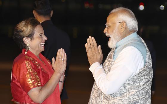 India's Prime Minister Narendra Modi, right, is met by Australian politician Michelle Rowland, left, as he arrives at the Sydney international airport on Monday, May 22, 2023, to begin his three-day visit to Australia.