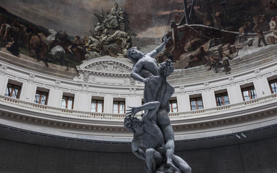 A replica of the 16th-century sculptor Giambologna's 'Rape of the Sabine Women', one of nine wax figures that comprise Urs Fischer's 2011-2020 work "Untitled" at the "Ouverture" exhibition in the Boerse De Commerce in Paris on May 14, 2021. 