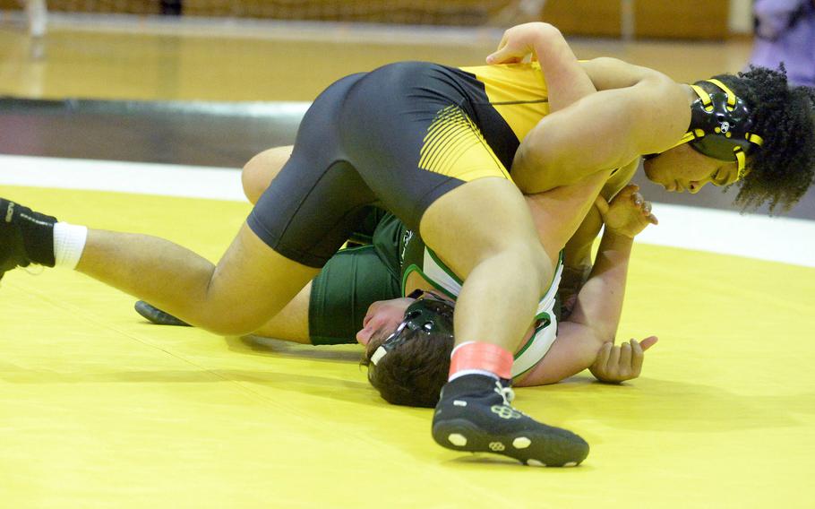 Kadena 215-pounder Jeremiah Drummer gains the edge on Kubasaki's Evan Swan during Wednesday's Okinawa wrestling regular-season finale. Drummer won by pin in 1 minute, 11 seconds and the Panthers completed a six-meet regular-season sweep 34-28.