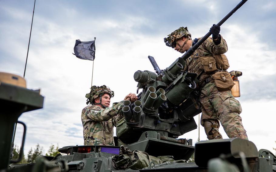 U.S. soldiers prepare a machine gun on a Stryker during an exercise at Bemowo Piskie Training Area, Poland, Oct. 6, 2021. A razor-wire wall will be erected along Poland’s border with the Russian military exclave of Kaliningrad, about 50 miles from Bemowo Piskie.